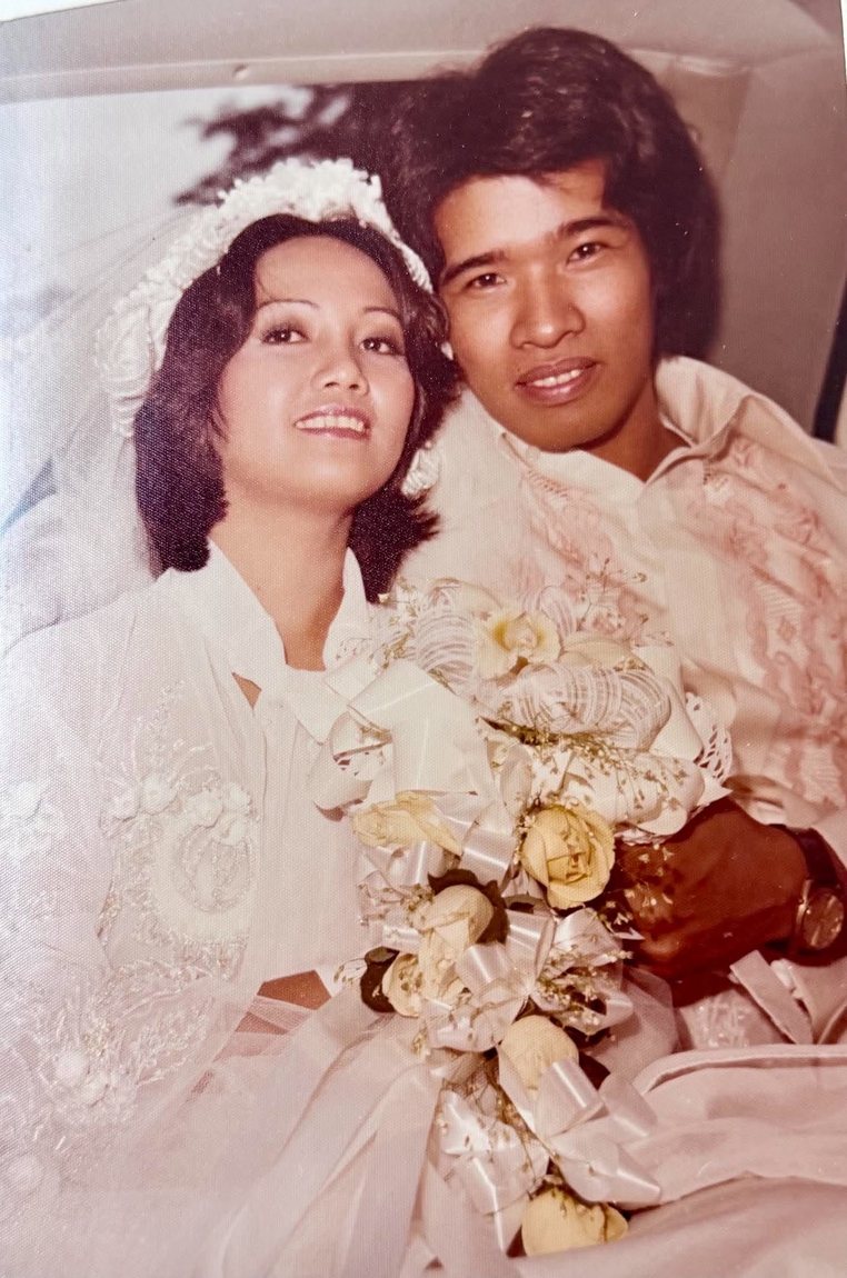 Eric and Star seated together with the bridal bouquet